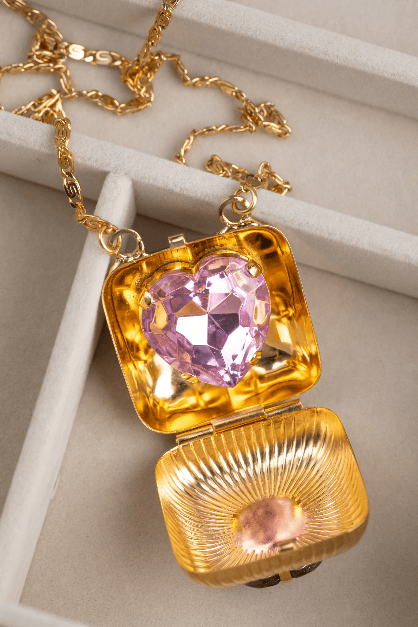 Golden locket with heart shaped pink stone - Anton Heunis