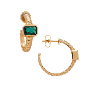 Golden hoop earrings with emerald detail