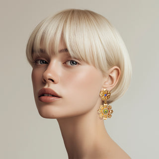 Woman wearing golden metal flowers statement earrings - Anton Heunis