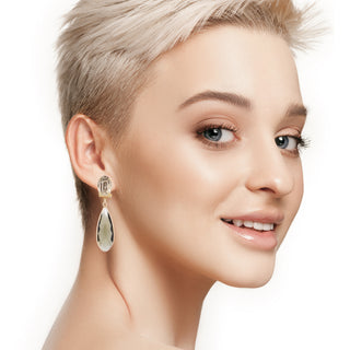 Greige drop statement earrings on model Anton Heunis