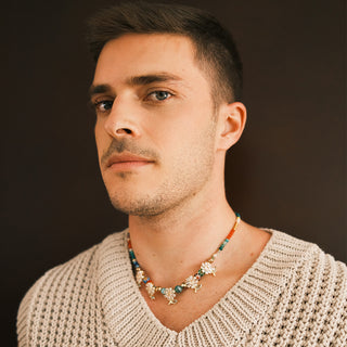 Man wearing a beaded daisy necklace - Anton Heunis