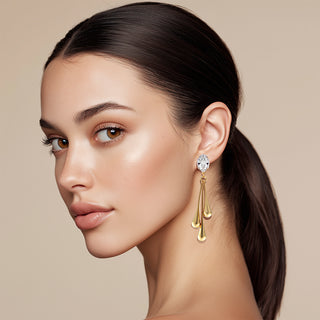 Model wearing Liquid metal golden earrings with crystal top and three drops - Anton Heunis