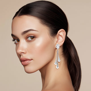 Model wearing Liquid metal silver earrings with crystal top and three drops - Anton Heunis
