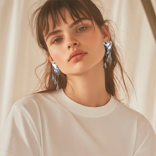 Model wearing Silver liquid metal earrings with three long drops - Anton Heunis