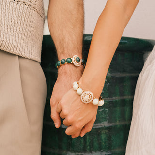 Two people holding hands with stunning statement bracelets - Anton Heunis