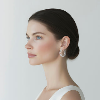 Woman wearing Dainty silver hoop earrings adorned with delicate pearls - Anton Heunis