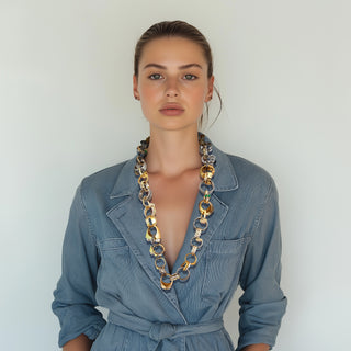 Woman wearing a mixed metals chunky statement necklace - Anton Heunis