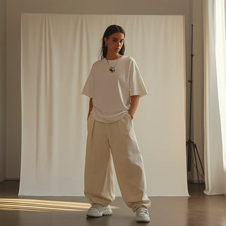 Woman wearing a silver chain necklace with dangly vintage rings mixed metals - Anton Heunis