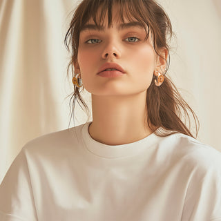 Woman wearing dainty hoops with eye detail - Anton Heunis