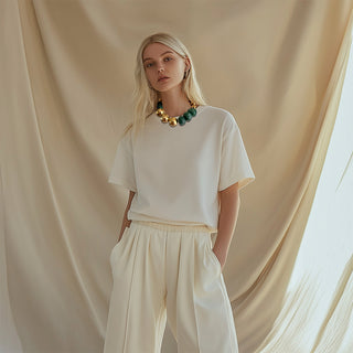 Woman wearing green and gold bubble statement necklace - Anton Heunis